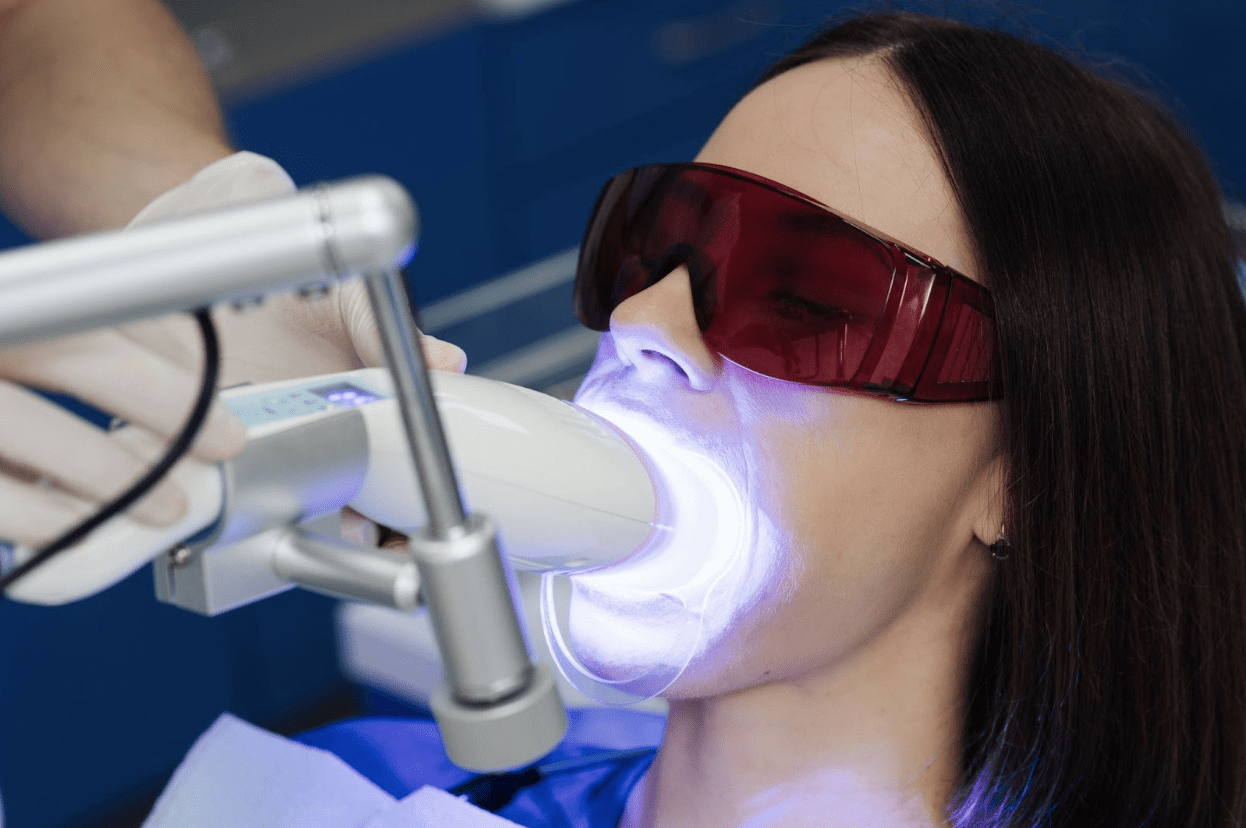 patient getting teeth whitened at the dentist