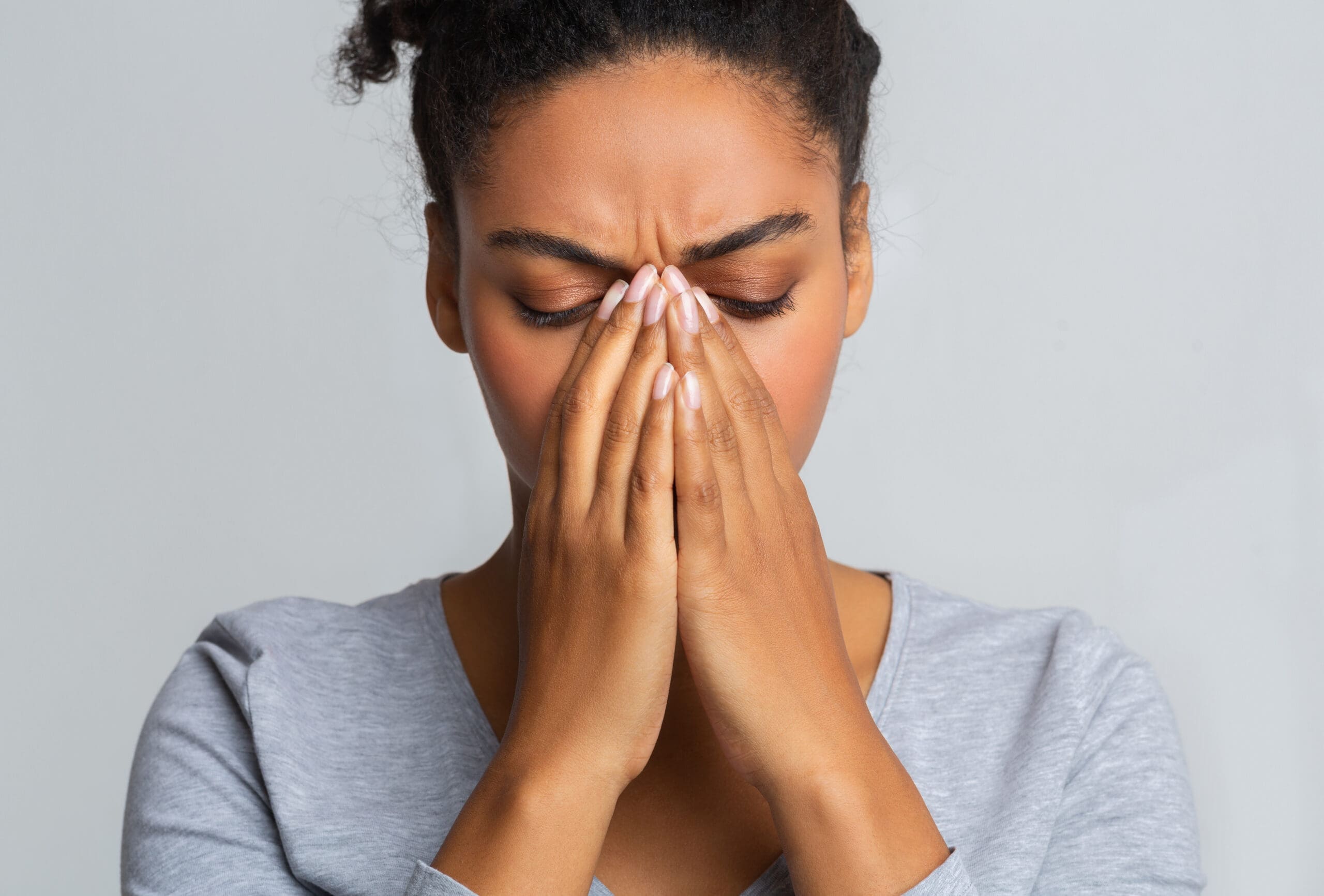 woman touching nose bridge