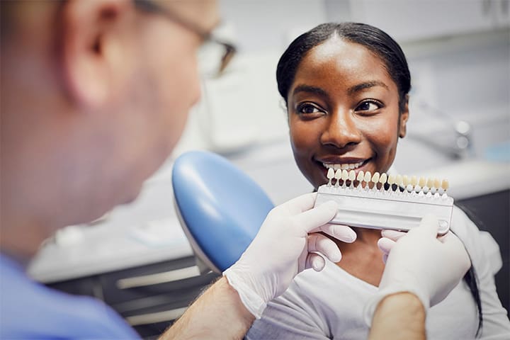 Weston patient comparing tooth shades after whitening
