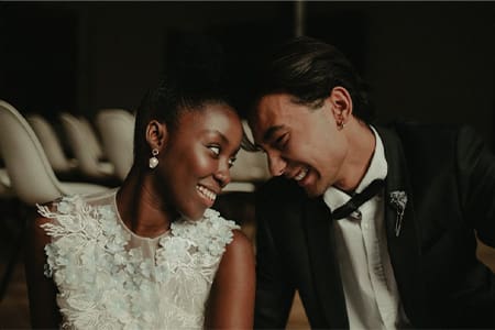 Smiling patients in wedding clothes after teeth whitening.